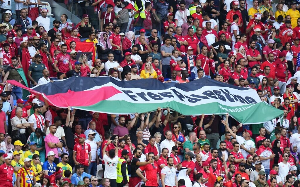 Supporters of Tunisia hold a flag of Palestine that reads "Free Palestine" during the World Cup group D soccer match between Tunisia and Australia at the Al Janoub Stadium in Al Wakrah, Qatar, Saturday, Nov. 26, 2022. (AP Photo/Petr David Josek)
